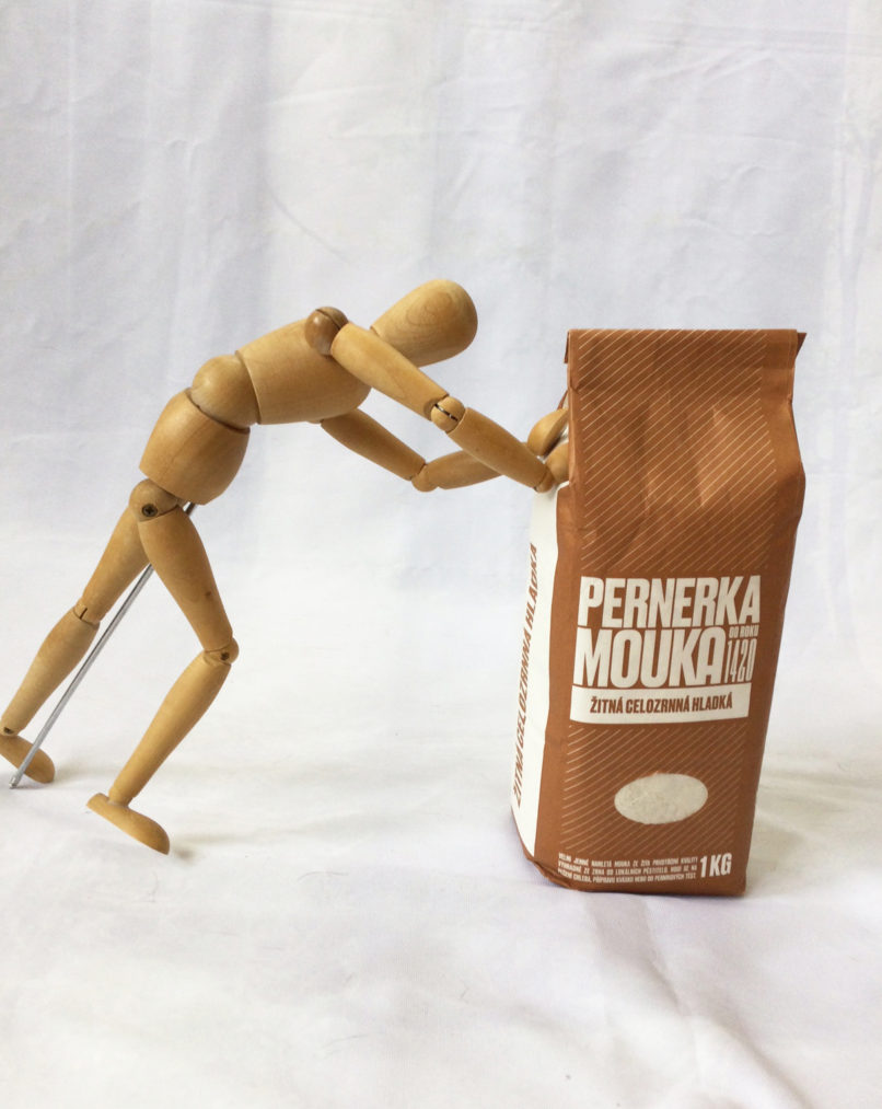 aranžmá dřevěné postavičky a produktu z prodejny